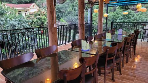 a row of tables and chairs on a deck at Trang An by Linh Homestay in Nguyên Ngoại