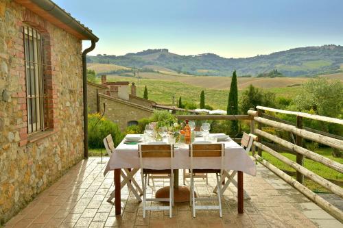 a table and chairs on a patio with a view at Locanda Le Giunche in Guardistallo