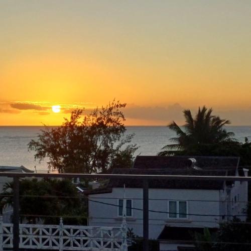 a sunset from the roof of a house with the ocean at Mont Choisy 2BR Private Rooftop and Plunge Pool in Mont Choisy
