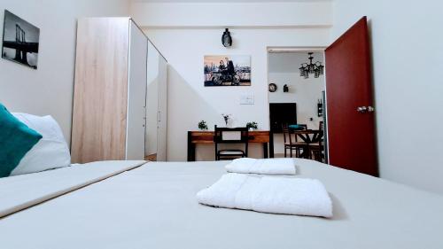 a bedroom with a white bed and a desk at Luxury 1BHK Premium Furnished Flat,WiFi, Near BAGA in Arpora