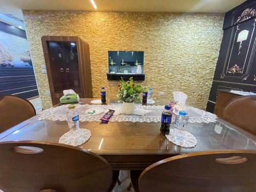a table in a room with chairs and a tableablish at شقة فندقية في المهندسين جامعة الدول in Cairo