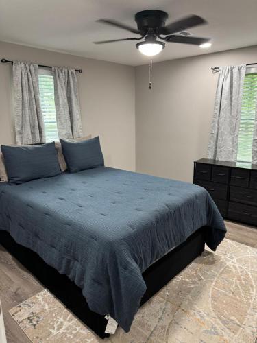 a bedroom with a bed and a ceiling fan at Mae's Place in Savannah