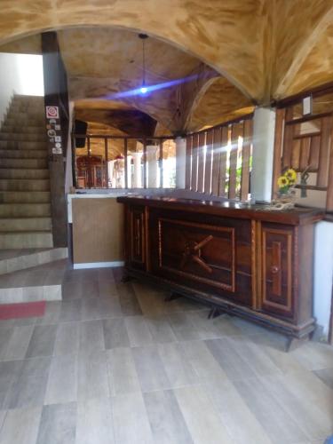 a room with a desk in a building with stairs at EBORA Afro Cultural in Ilhéus