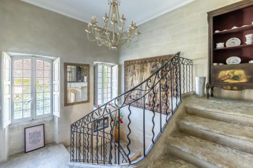 a staircase in a home with a chandelier at Domaine de Rhodes B&B in Avignon