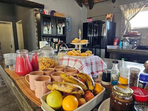 a table with a bunch of fruits and other foods at Carlo's Mountain Lodge in Usakos