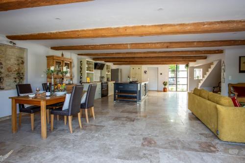 a kitchen and living room with a table and chairs at Chic Converted Stables in Laurens