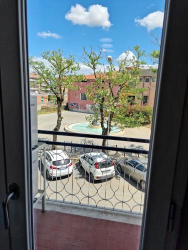 a view of a parking lot with parked cars from a window at Casa Vacanze Fiore Ciampino Airport - Rome Station - 108 mqs in Ciampino