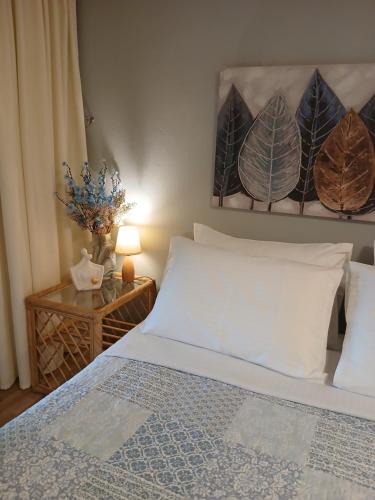 a bedroom with a bed and a table with a lamp at Andromache City Center Cozy Apartment in Rethymno Town