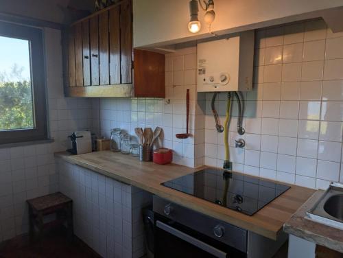 a kitchen with a sink and a counter top at 4Sea House in Porto Covo
