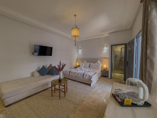 a living room with a bed and a couch at Riad Tonaroz Gold in Marrakech