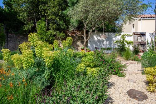 a garden with colorful flowers and a fence at Chic Converted Stables in Laurens