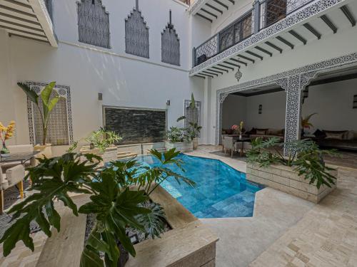 a courtyard with a swimming pool in a house at Riad Tonaroz Gold in Marrakech
