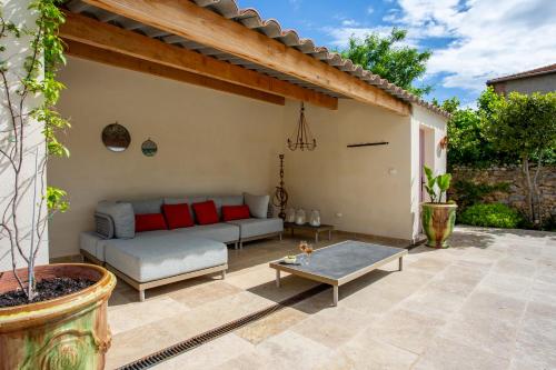 a patio with a couch and a table at Chic Converted Stables in Laurens