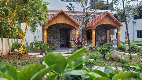 a house with a garden in front of it at Trang An by Linh Homestay in Nguyên Ngoại