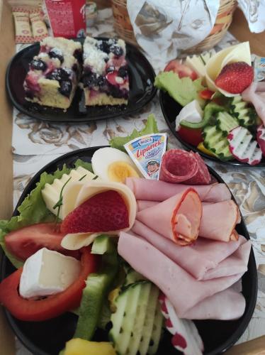 two plates of food with meat and vegetables on a table at Apartment Telč Hradecka in Telč