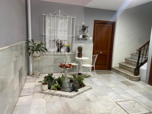 a living room with a table and some plants at Escapada junto a Picasso in Málaga