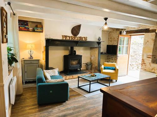a living room with a couch and a fireplace at La maison d'iréne in Soturac