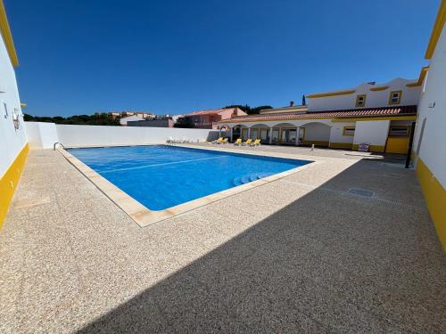 a swimming pool in the middle of a building at AP Roberand in Albufeira