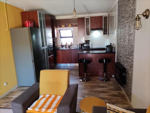 a living room with a couch and a kitchen at Faro,Algarve in Bicas