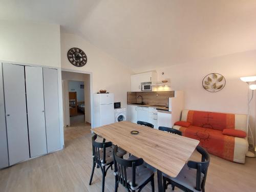 a kitchen and dining room with a table and a couch at Village de gîtes La Fontinelle in Bessas