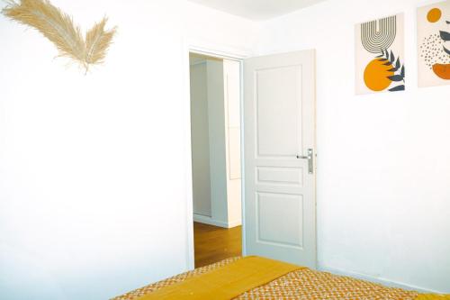 une chambre avec une porte ouverte et un lit dans l'établissement Elegancia Stade de France, proche Paris, à Pierrefitte-sur-Seine