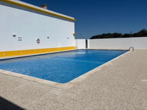 a swimming pool in the side of a building at AP Roberand in Albufeira