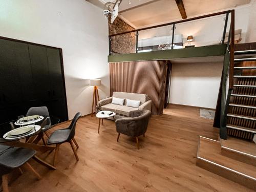 a living room with a couch and a table and chairs at Studio Centro - Luxury Apartment at Pylos Center in Pylos