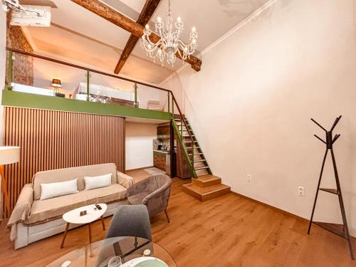 a living room with a couch and a staircase at Studio Centro - Luxury Apartment at Pylos Center in Pylos