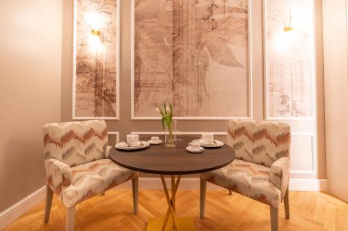 a dining room with a table and two chairs at VILLA MADRE Suites e Private Spa in Grottaferrata