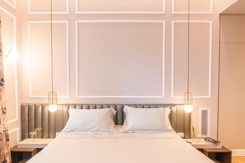 a bedroom with a large bed with two pillows at VILLA MADRE Suites e Private Spa in Grottaferrata