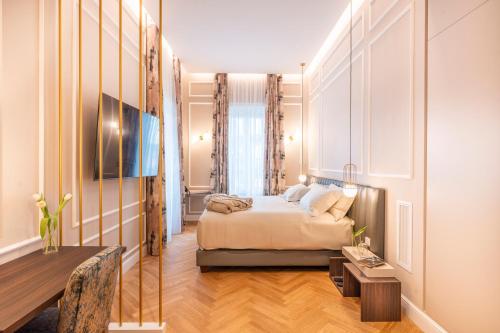 a hotel room with a bed and a table at VILLA MADRE Suites e Private Spa in Grottaferrata