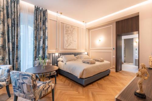 a bedroom with a bed and a living room at VILLA MADRE Suites e Private Spa in Grottaferrata
