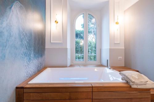 a large bath tub in a bathroom with a window at VILLA MADRE Suites e Private Spa in Grottaferrata