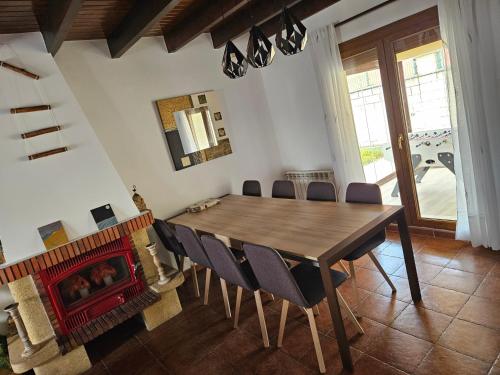 a dining room with a table and a fireplace at Alojamientos Marte casa rural in Suances