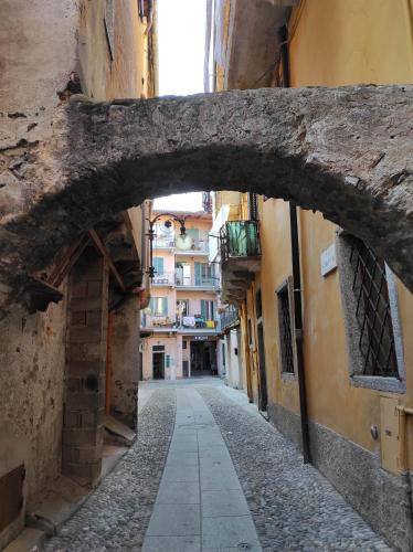 an alley with an archway in a city with buildings at At the lake in Intra