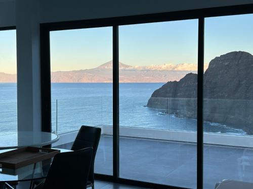 a dining room with a view of the ocean at Brisa y Marea in Hermigua