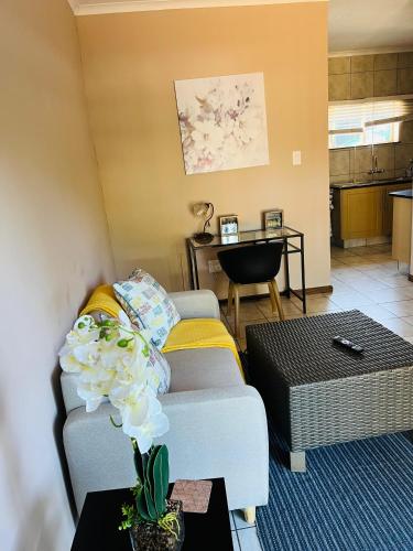 a living room with a couch and a table at 9 on Deimos Ave in Polokwane