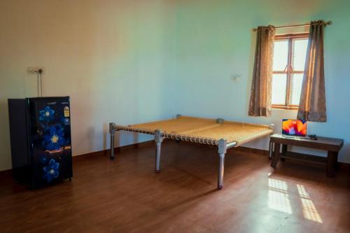 a room with a bed in the corner of a room at Chaudhary Farm house in Daula