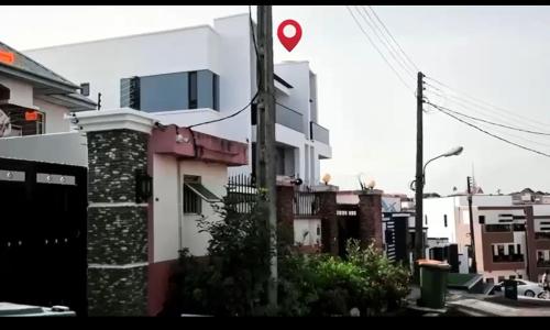 a white building with a red heart on top of it at Sohana Homes in Ikeja