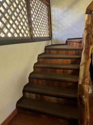 a set of stairs in a house with a window at Villa Tropical in Cahuita