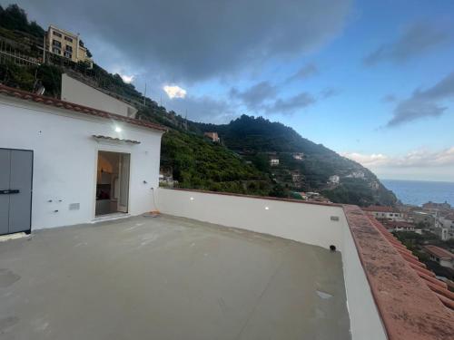 a balcony of a white building with a view of the ocean at Song of the sea, Amalfi Coast in Minori
