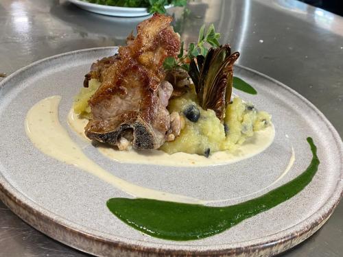 a plate with a piece of food on a table at La Nine in Aigne
