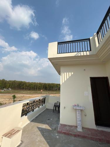 a balcony of a building with a bench on it at Sukoon Guaranteed in Jhājra