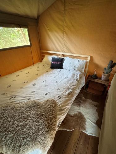 a bedroom with a bed in a tent at Wild Wild West Saloon in Paasloo
