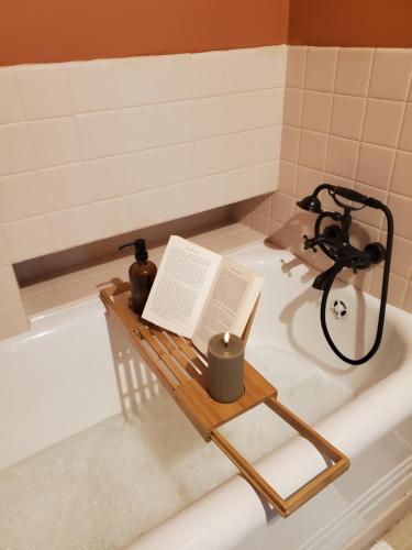 un livre posé sur un plateau dans une baignoire dans l'établissement L'Echiquier, à Castres