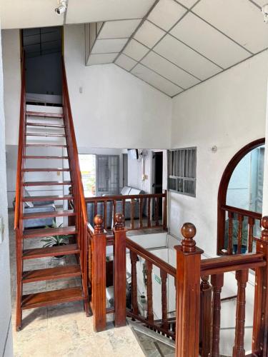 a staircase in a house with wooden railings at Hotel Regional in La Dorada