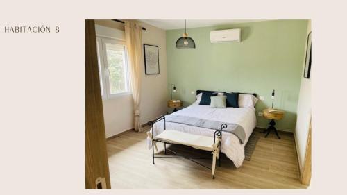 a bedroom with a bed and a chair at Finca Avellaneda in Navahonda