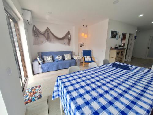 a living room with a bed and a couch at Ferreirinhas - Beach House in Vila do Conde