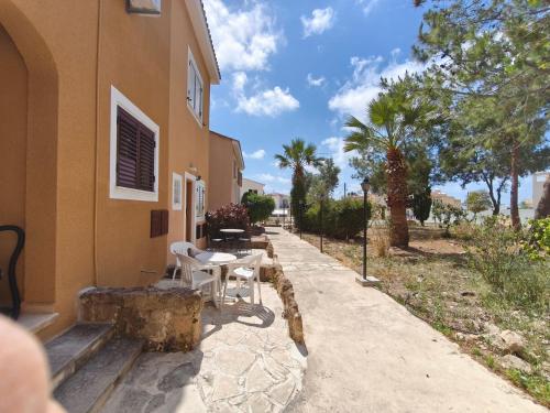 a table and chairs sitting outside of a building at Eden gardens in Paphos
