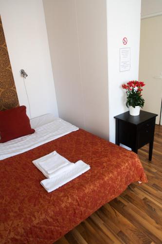 a hotel room with a bed with towels on it at Hotel Homeland in Tampere